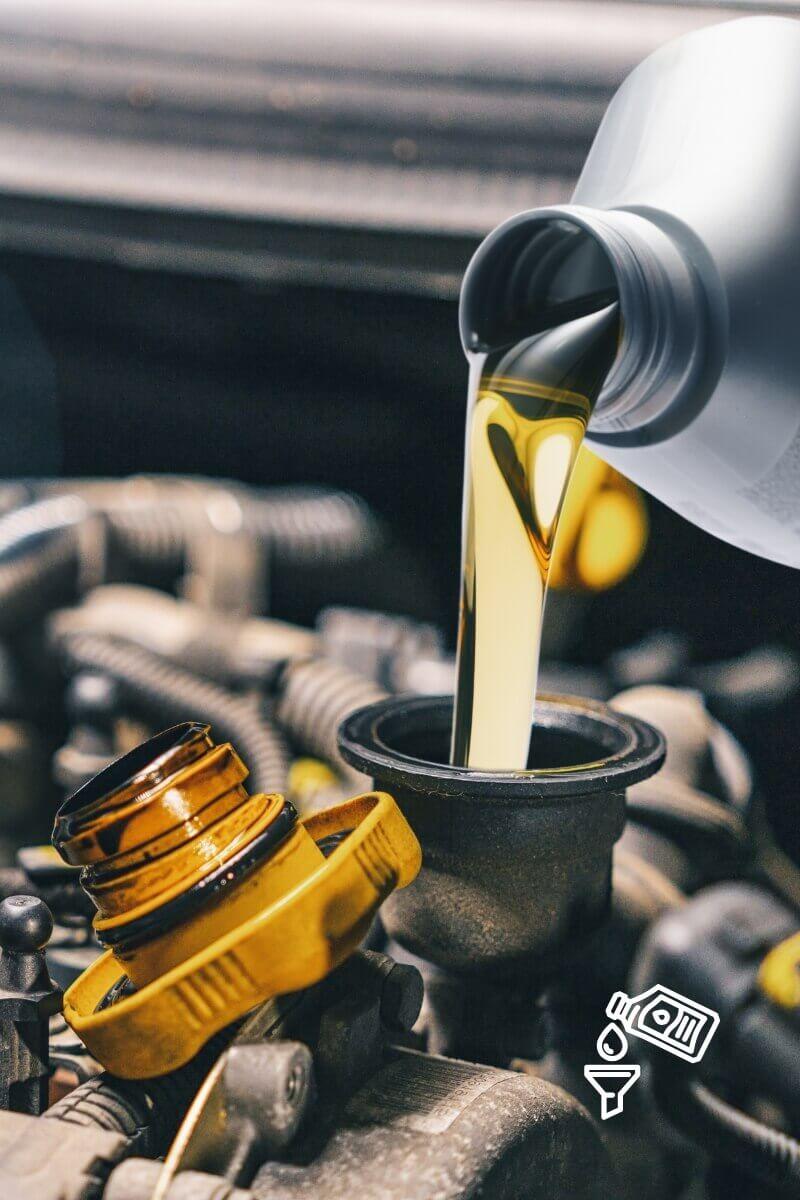 quart of motor oil being poured into engine