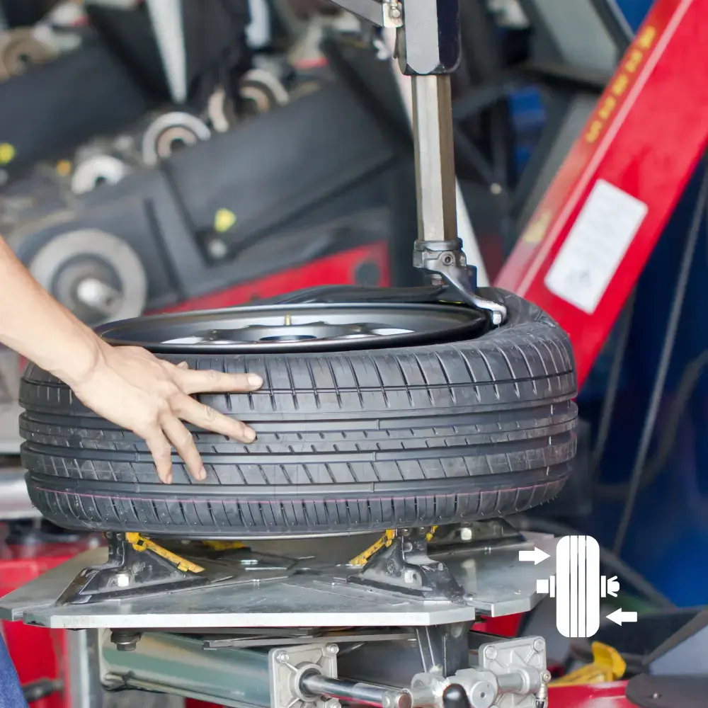 Tire changer with dual helper arms in the service bay at The PitStop Fremont